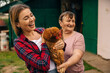 © Ivan - Happy farmers holds her favorite chicken in her hands and talks to it Focus on the chicken