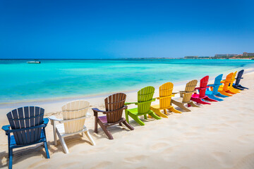 Canvas Print - Idyllic beach with rustic adirondack chairs in Aruba, Dutch Antilles