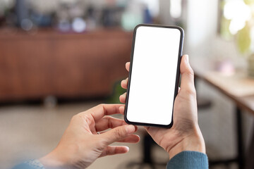 cell phone blank white screen mockup.hand holding texting using mobile on desk at office.background 