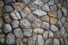 Background texture of Rough stone wall, Stone cladding, Old castle stone wall, Grey, brown Color, Close up shot