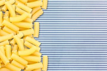 Wall Mural - Penne pasta. Raw italian pasta on background,