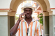 © ADDICTIVE STOCK - Black man having phone conversation on street