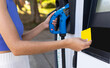 © ADDICTIVE STOCK - Unrecognizable woman paying for refueling car at station