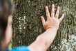 © ADDICTIVE STOCK - Crop unrecognizable child touching tree trunk