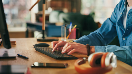 Fototapete - Close Up on Hands of a Man Working from Loft Apartment on Desktop Computer. Creative Male Typing on Keyboard, Checking Social Media, Browsing Internet from Home.