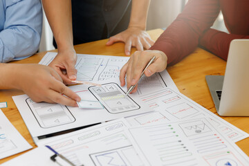 Wall Mural - ux ui concept, graphic designers work together with ux ui designer planning application template lay