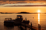 Fototapeta Zachód słońca - boats moored on a pier illuminated by the midnight sun at Sommaroy island (Sommarøy). Tromso Norway