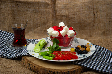 Turkish breakfast plate with plaid cover placed on wood