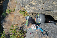 Person Climbing Up A Rock And Clipping Quickdraw