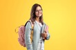 Leinwandbild Motiv cheerful teen girl carry backpack, school fashion