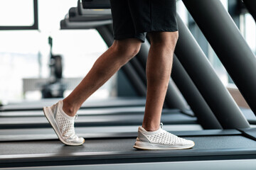 Wall Mural - Jogging Workout. Cropped Shot Of Black Male Training On Treadmil At Gym