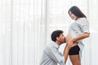 © DJ Creative Studio - Happy Family - New Parent Dad and Mom,Husband Kissing on the Belly of His Wife with Love