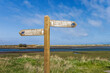 England coast path at the esturay of the river Coquet in Northumberland, Uk with signpost