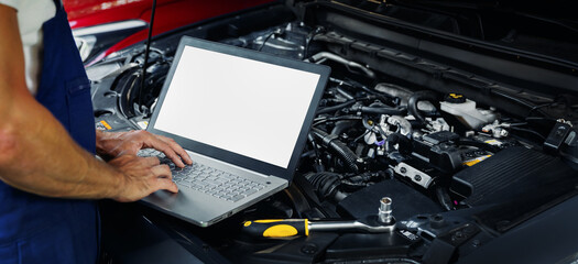 Wall Mural - engine diagnostics - car mechanic using laptop computer to diagnose vehicle motor in repair shop. bl