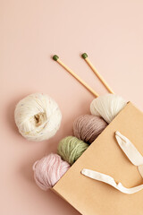 Craft hobby background with yarn in natural colors. Recomforting hobby to reduce stress for cold fall and winter weather. Mock up, copy space, top view