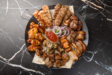 Poster - platter of different kebabs, kebab of pork, lula kebab, rack of lamb,chicken kebab,kebab of veal, grilled vegetables on plate saj top view