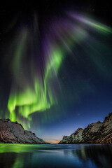 aurora borealis above the mountains