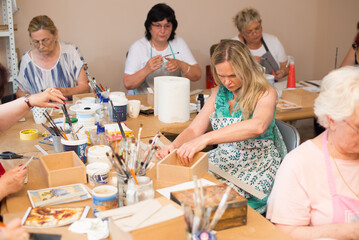 Wall Mural - Women in art workshop making decoupage boxes