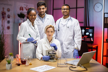 Wall Mural - Portrait of a young team of multinational scientists, looking at the camera, satisfied with the results of their research.