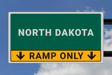 North Dakota Logo.  North Dakota Lettering On A Road Sign. Signpost At Entrance To  North Dakota, USA. Green Pointer In American Style. Road Sign In The United States Of America. Sky In Background