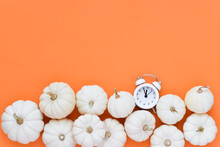 Minimal White Pini Pumpkins On Bottom With Clock On Orange