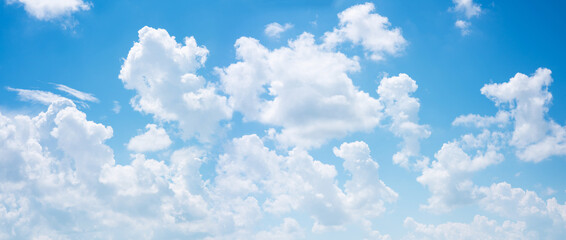 Wall Mural - abstract white puffy clouds and blue sky background.