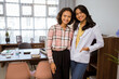 © Odua Images - smiling female patient and female doctor standing looking at camera in examination room