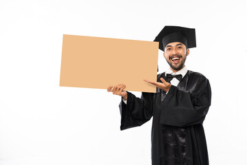 Wall Mural - Excited graduate male students wearing toga holding blank space carton standing on isolated background