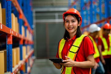 Portrait of a smiling female employee standing in a warehouse. Freight and warehouse distribution, industrial and industrial labor concepts. International export concept