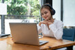 © Natee Meepian - Online education, e-learning. young woman studying remotely, using a laptop, listening to online webinar at home