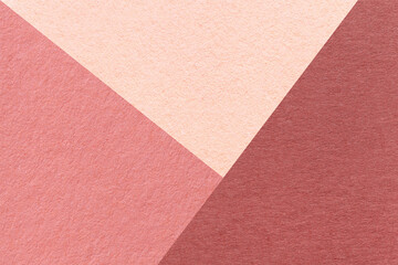 Wall Mural - Texture of craft red, pink and coral shade color paper background, macro. Structure of vintage abstract rose cardboard with geometric shape and gradient. Felt maroon backdrop closeup.