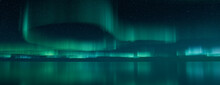 Northern Lights Banner. Blue Aurora Sky Reflected In Water With Copy-space. 