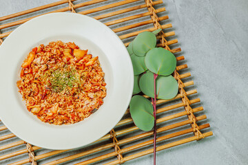 Wall Mural - Korean food Kimchi Fried Rice Kimchibokkeumbap, Rice fried with finely chopped kimchi. Beef, pork, onions, green onions, and other vegetables may be added according to taste.