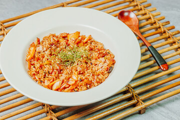 Wall Mural - Korean food Kimchi Fried Rice Kimchibokkeumbap, Rice fried with finely chopped kimchi. Beef, pork, onions, green onions, and other vegetables may be added according to taste.