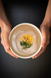 © changju.kang - person holding a bowl of pasta