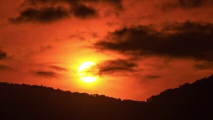 Sticker - Timelapse of dramatic sunset with orange sky in a sunny day.