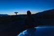 © Elijah Hurwitz - silhouette of a person looking at radio telescope in wide open space