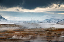 Anonymous People Standing In Geothermal Valley In Mountains