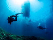 Anonymous Diver Underneath Old Sunken Ship
