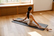 © Drobot Dean - Young white woman doing exercise on mat during yoga practice