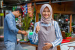 © Odua Images - proud young muslim woman standing in front of her small traditional food shop and showing thumb up oke gesture