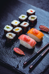 Canvas Print - Assortment of vegan sushi with vegetables, seitan, Konjac plant, tofu as fish substitutes, with finger lime as caviar on black