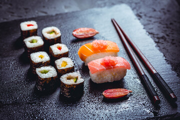 Wall Mural - Assortment of vegan sushi with vegetables, seitan, Konjac plant, tofu as fish substitudes, with finger lime as caviar on black