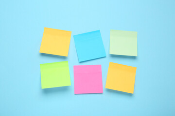 Sticker - Blank colorful sticky notes on turquoise background, flat lay. Space for text