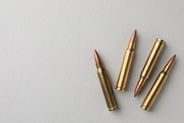 Wall Mural - Brass bullets on white background, flat lay. Space for text