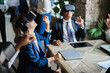 © DisobeyArt - Business people wearing virtual reality goggles inside office - Focus on senior woman headset