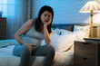 © PR Image Factory - unhappy Asians pregnant female with depression and insomnia is propping her face while sitting alone at bedside late at night in the bedroom.