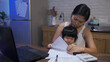 © PRPicturesProduction - naughty asian little girl is bothering her multitasking mother by grabbing the document and pen as she is filing taxes online on the laptop at home.