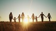 community large family in the park. a large group of people holding hands walking silhouette on nature sunset in the park. big lifestyle family kid dream concept. people in the park. large family