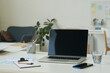 © AnnaStills - Horizontal image of workplace of business person with laptop and smartphone on table